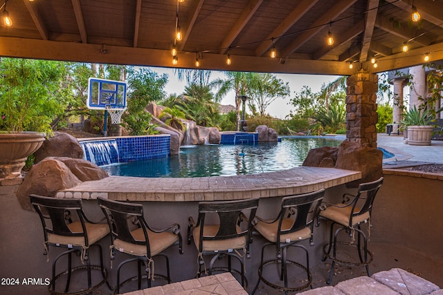 exterior space with exterior bar, pool water feature, and a gazebo