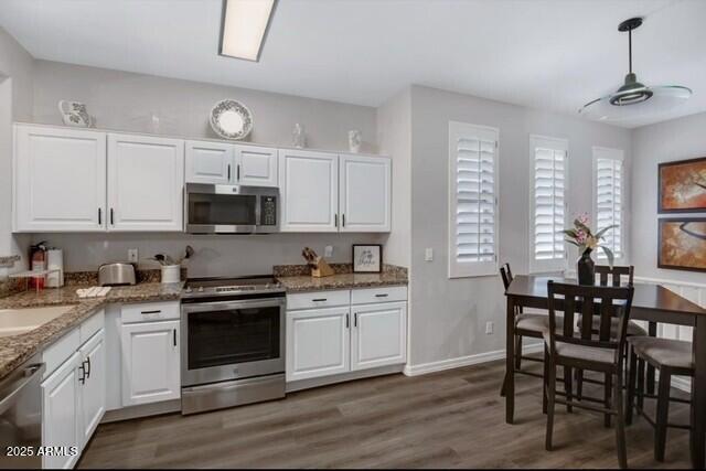 15221 N Clubgate Dr Unit 2096, Scottsdale, AZ 85254 - kitchen with stainless steel appliances, white cabinets, dark wood finished floors, and light stone countertops