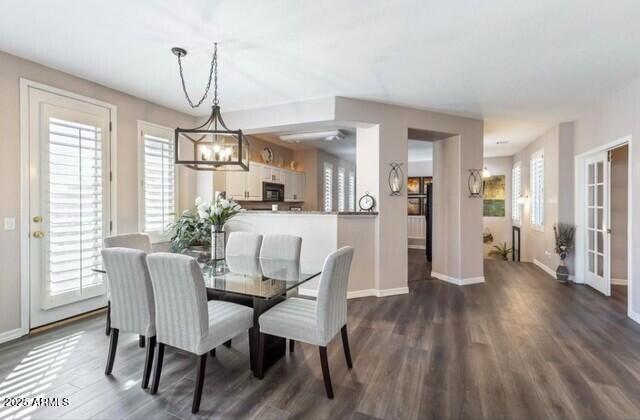 15221 N Clubgate Dr Unit 2096, Scottsdale, AZ 85254 - dining area with a chandelier, dark wood finished floors, and healthy amount of natural light