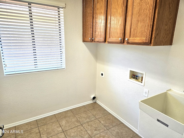 laundry room with cabinets, sink, washer hookup, hookup for an electric dryer, and light tile patterned flooring