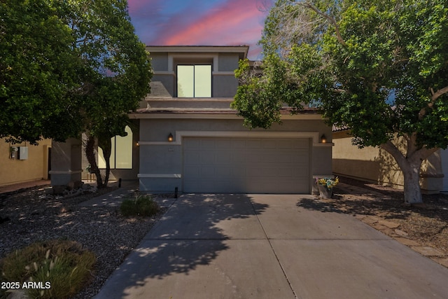 11526 W Bermuda Dr, Avondale, AZ 85392 - view of front facade with stucco siding, concrete driveway, and an attached garage