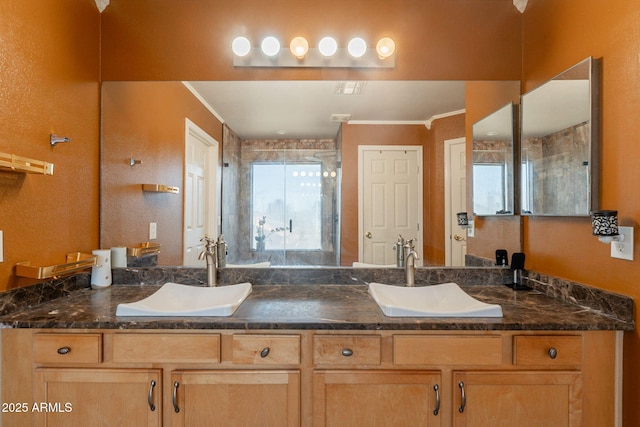 11526 W Bermuda Dr, Avondale, AZ 85392 - bathroom featuring ornamental molding, double vanity, a shower stall, and plenty of natural light