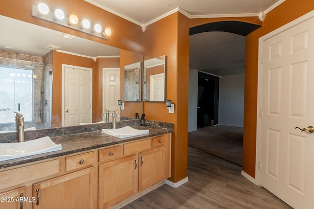 11526 W Bermuda Dr, Avondale, AZ 85392 - bathroom featuring double vanity, a shower stall, wood finished floors, ornamental molding, and baseboards