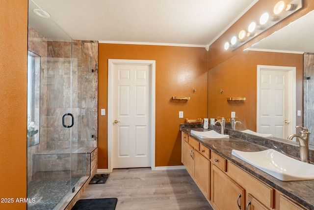 11526 W Bermuda Dr, Avondale, AZ 85392 - full bath featuring double vanity, a stall shower, wood finished floors, baseboards, and crown molding