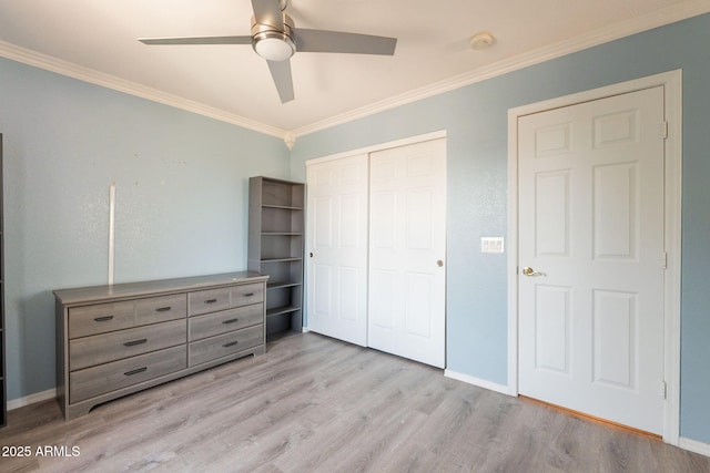 11526 W Bermuda Dr, Avondale, AZ 85392 - unfurnished bedroom with wood finished floors, ornamental molding, a closet, baseboards, and ceiling fan