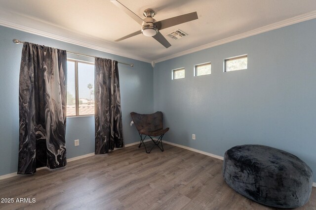 11526 W Bermuda Dr, Avondale, AZ 85392 - sitting room featuring crown molding, ceiling fan, wood finished floors, and baseboards