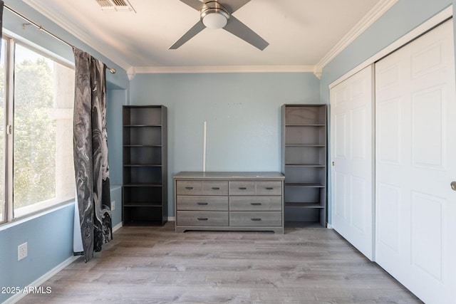 11526 W Bermuda Dr, Avondale, AZ 85392 - bedroom with multiple windows, crown molding, a closet, wood finished floors, and ceiling fan
