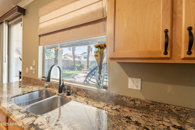 11526 W Bermuda Dr, Avondale, AZ 85392 - kitchen view of a sink, stone counters, and crown molding