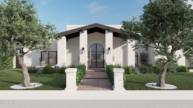 view of front of house featuring a front yard and stucco siding