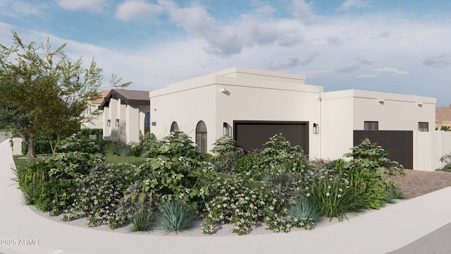 view of side of home featuring a garage and stucco siding