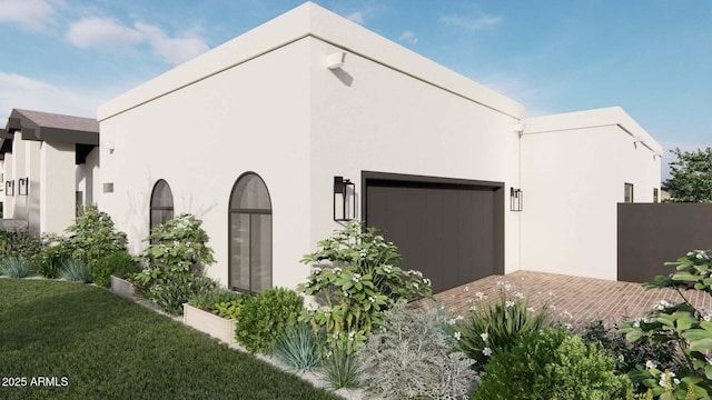 view of home's exterior with an attached garage, a yard, and stucco siding