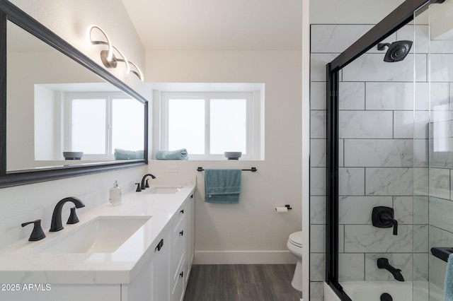 full bathroom with vanity, toilet, combined bath / shower with glass door, and wood-type flooring