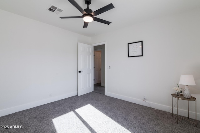 spare room with ceiling fan and carpet