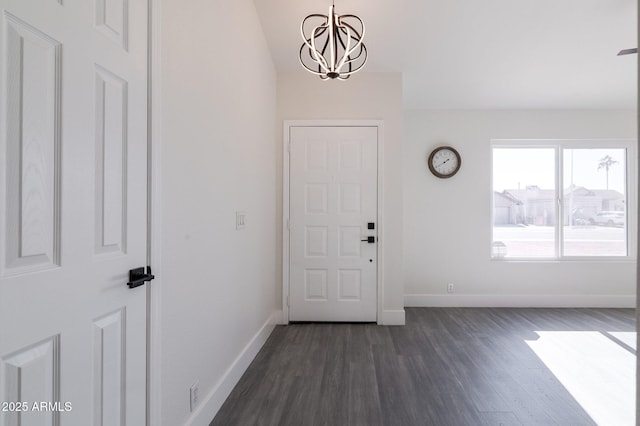 entrance foyer with an inviting chandelier and dark hardwood / wood-style floors