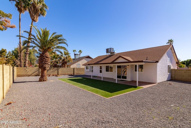 back of house featuring a yard and a patio