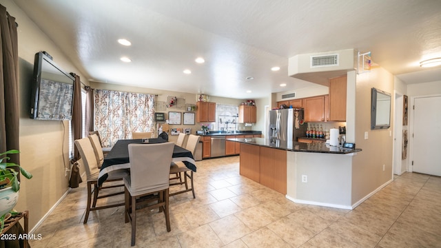 7274 W State Ave, Glendale, AZ 85303 - kitchen featuring appliances with stainless steel finishes, recessed lighting, brown cabinets, dark countertops, and a peninsula