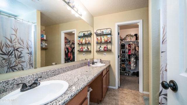 7274 W State Ave, Glendale, AZ 85303 - full bathroom with a spacious closet, double vanity, and tile patterned floors