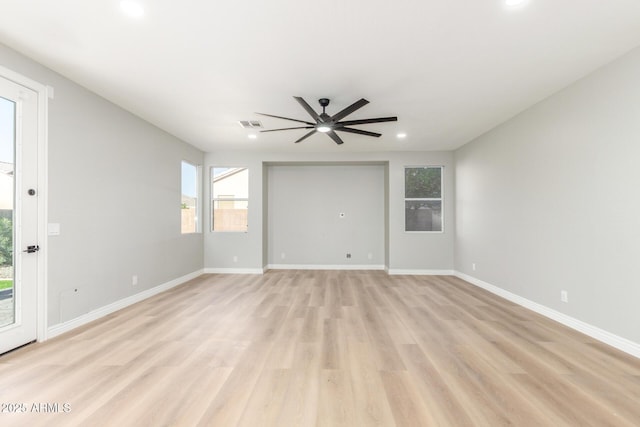 spare room with a ceiling fan, visible vents, baseboards, light wood-style floors, and recessed lighting