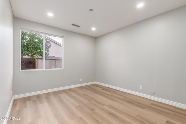 empty room featuring baseboards, recessed lighting, light wood-style flooring, and visible vents