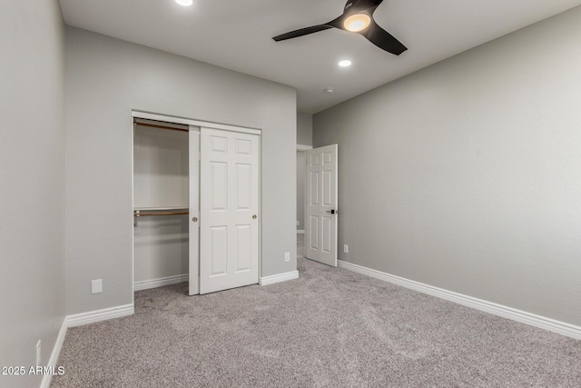 unfurnished bedroom with a closet, carpet flooring, baseboards, and recessed lighting