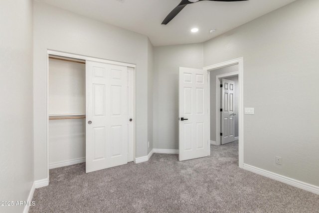 unfurnished bedroom with carpet floors, baseboards, a ceiling fan, and a closet