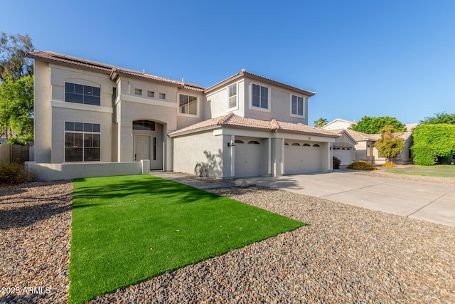 mediterranean / spanish house with a tiled roof, a front lawn, concrete driveway, an attached garage, and stucco siding