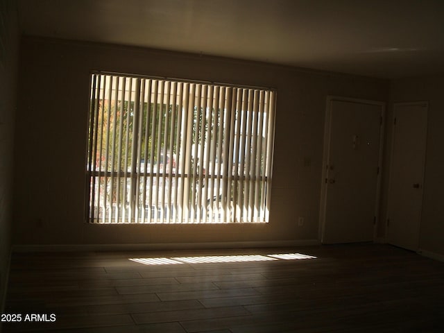 spare room with dark hardwood / wood-style floors