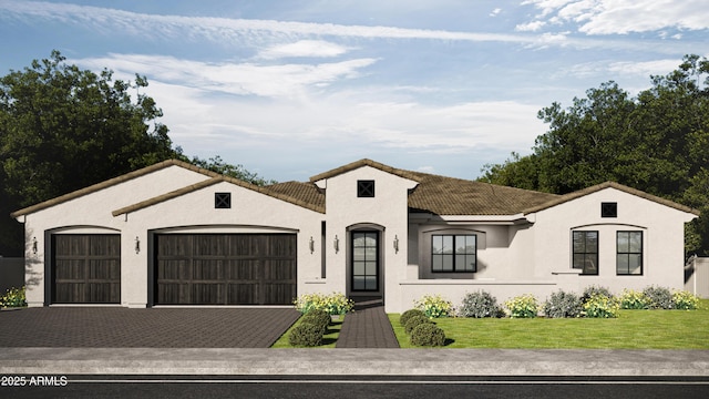 view of front of home with a garage and a front lawn