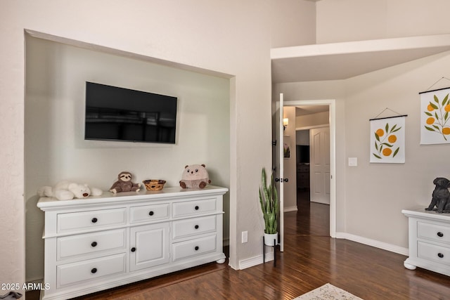 interior space with dark wood-type flooring and baseboards