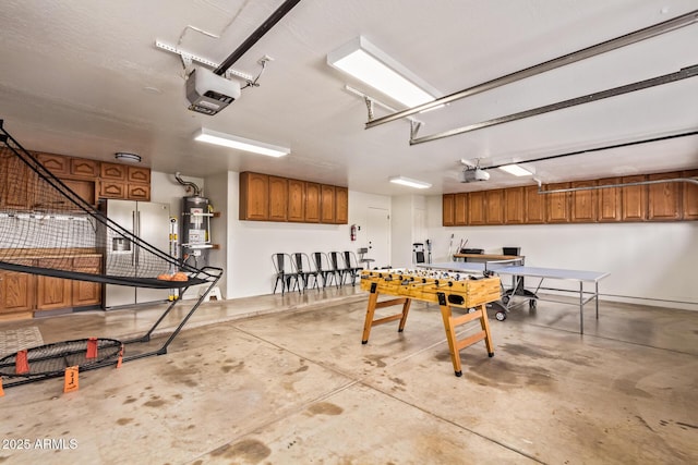 garage with secured water heater, a garage door opener, and freestanding refrigerator