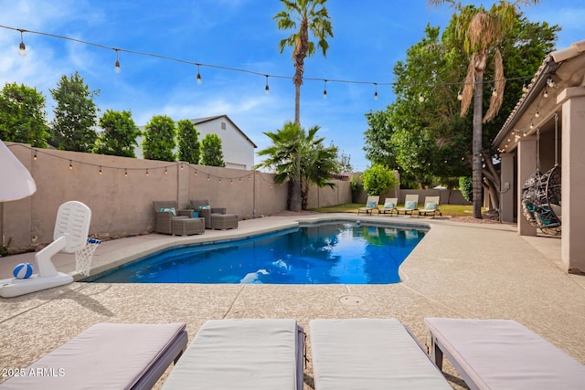 view of swimming pool featuring a fenced in pool, a fenced backyard, a patio area, and outdoor lounge area
