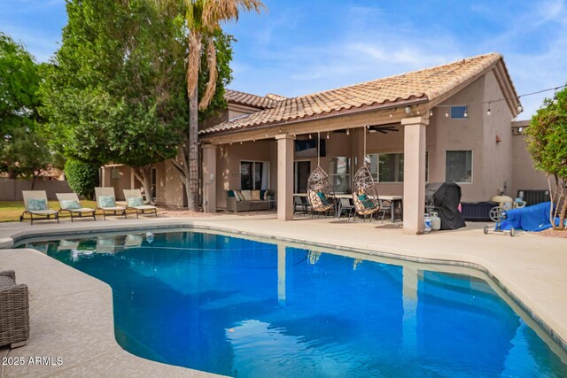 view of pool with an outdoor living space, ceiling fan, a fenced in pool, and a patio