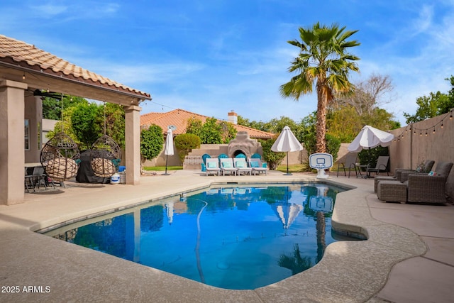 view of swimming pool featuring a patio, a fenced in pool, and a fenced backyard