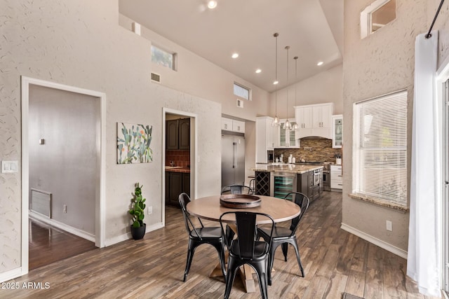 dining area with visible vents, dark wood finished floors, wine cooler, and baseboards
