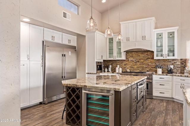 kitchen featuring beverage cooler, high vaulted ceiling, stainless steel appliances, visible vents, and dark wood-style floors