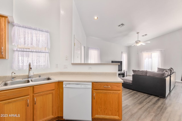 kitchen with light wood-type flooring, sink, dishwasher, kitchen peninsula, and ceiling fan