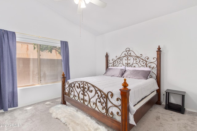 carpeted bedroom with ceiling fan and vaulted ceiling