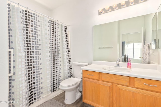 bathroom featuring wood-type flooring, vanity, and toilet