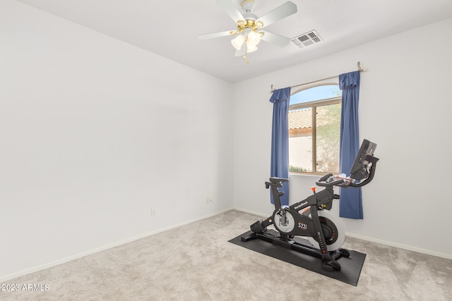 workout room featuring ceiling fan and light colored carpet