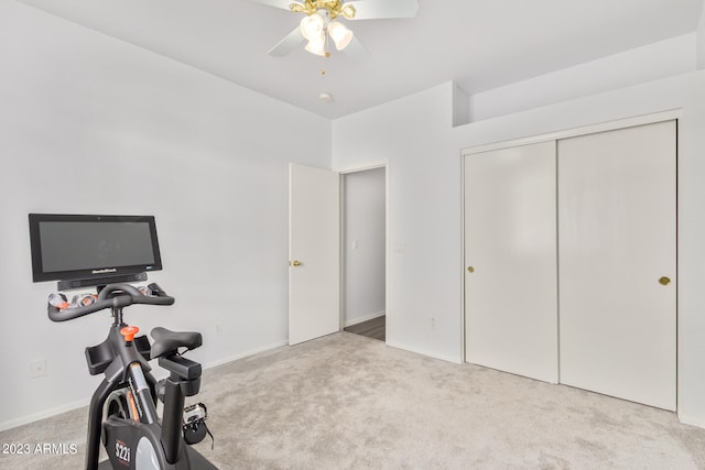 exercise room with ceiling fan and light colored carpet