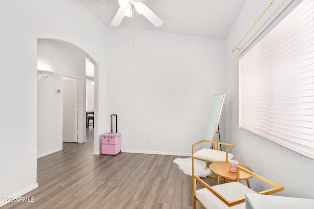 sitting room with hardwood / wood-style floors and ceiling fan