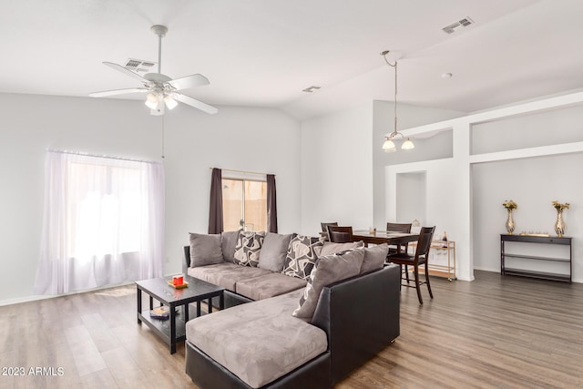 living room featuring ceiling fan, wood-type flooring, and vaulted ceiling