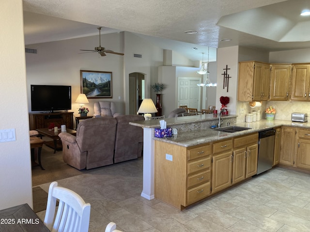 kitchen featuring vaulted ceiling, stainless steel dishwasher, kitchen peninsula, and sink