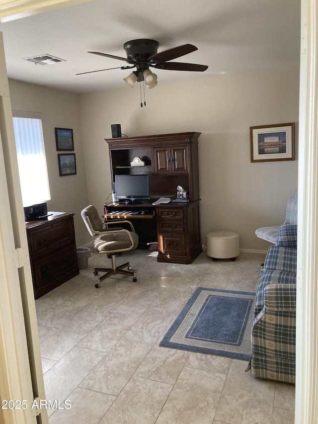 tiled office space featuring ceiling fan