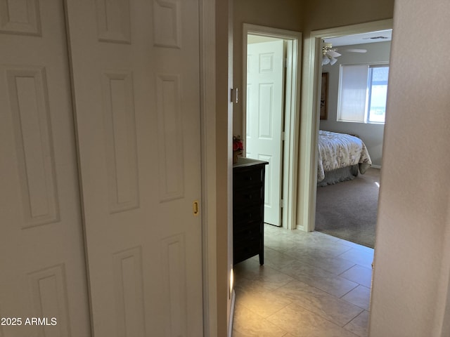 hall featuring light tile patterned floors