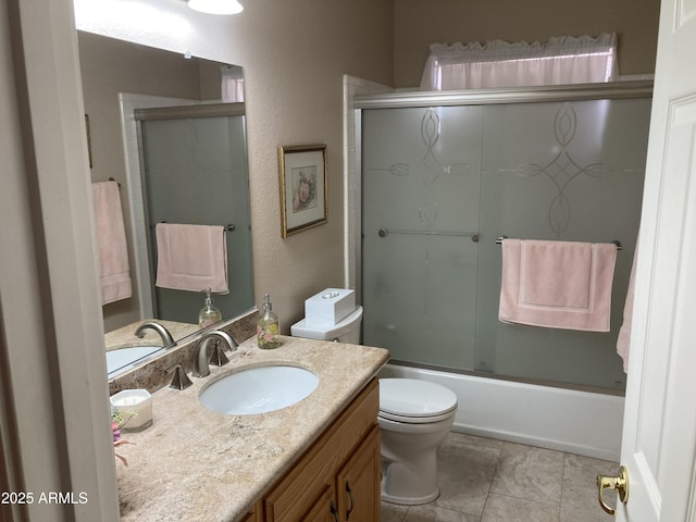 full bathroom with vanity, tile patterned floors, shower / bath combination with glass door, and toilet