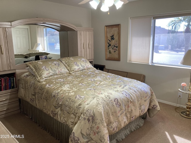 bedroom with ceiling fan and carpet flooring