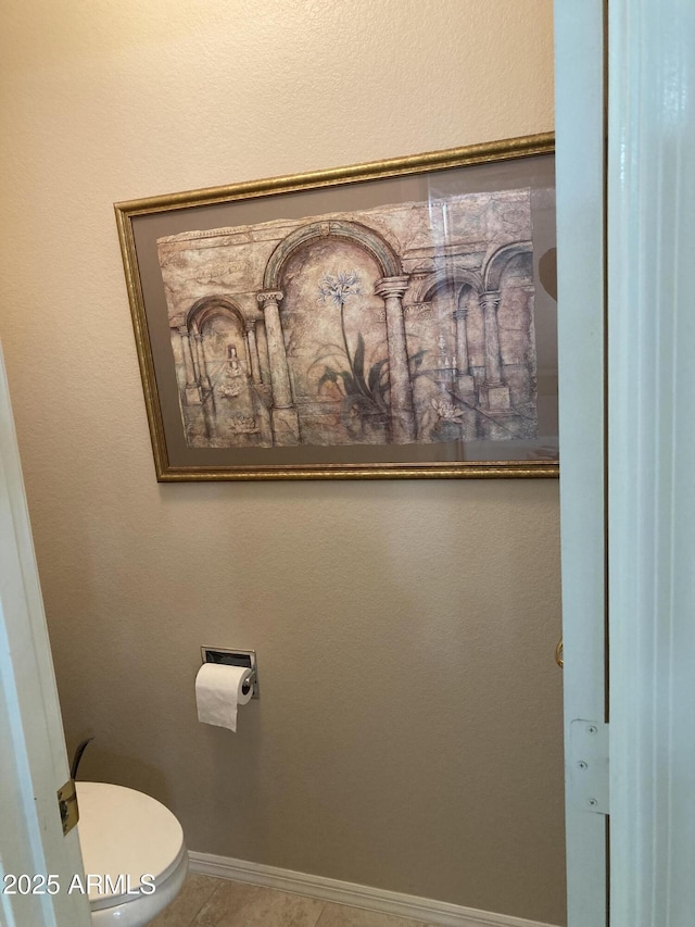 bathroom with toilet and tile patterned flooring