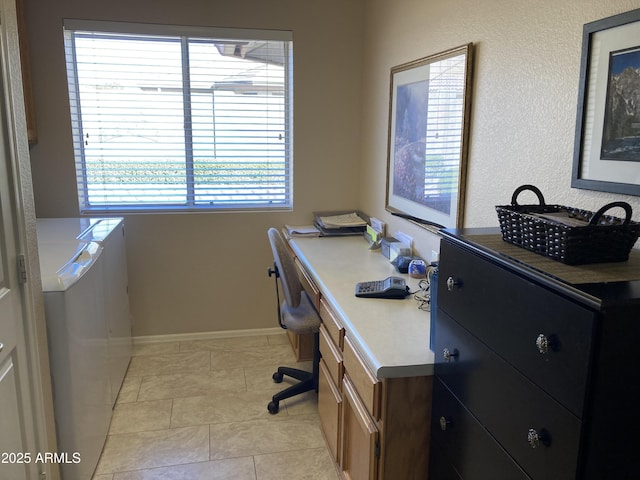 home office with washer / clothes dryer and light tile patterned floors