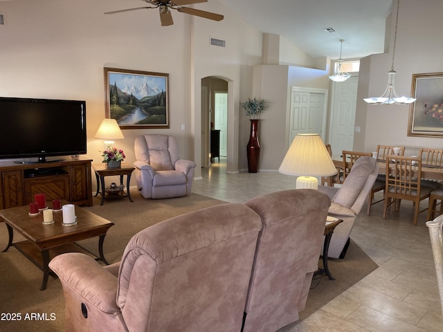 living room featuring ceiling fan and high vaulted ceiling